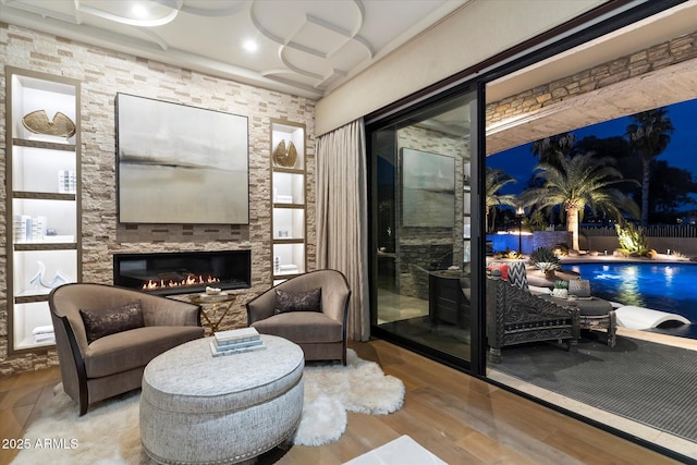 sitting room with a fireplace and light hardwood / wood-style flooring