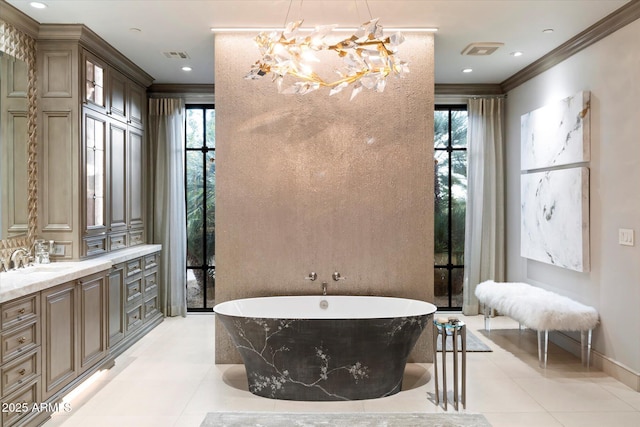 bathroom with plenty of natural light, ornamental molding, tile patterned flooring, and a washtub