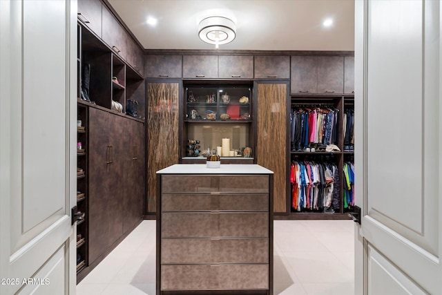 spacious closet with light tile patterned floors