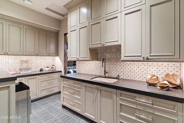 kitchen with tasteful backsplash, sink, and cream cabinetry