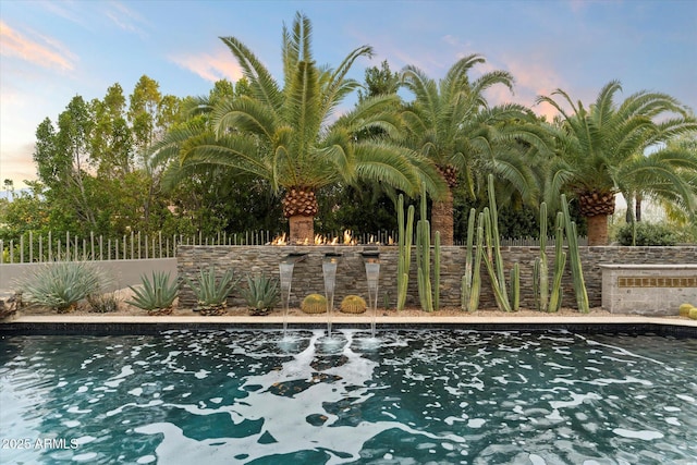 view of pool at dusk