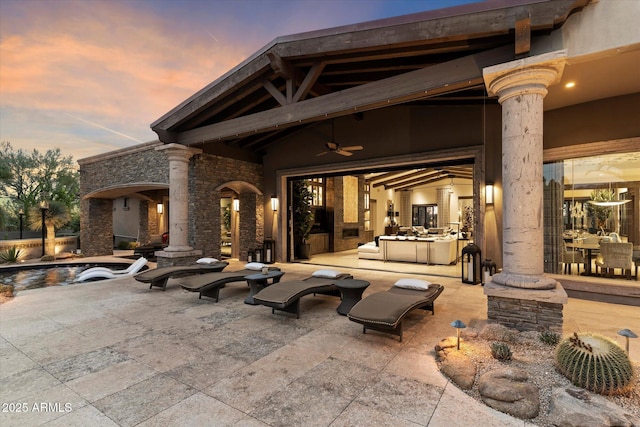 patio terrace at dusk featuring ceiling fan