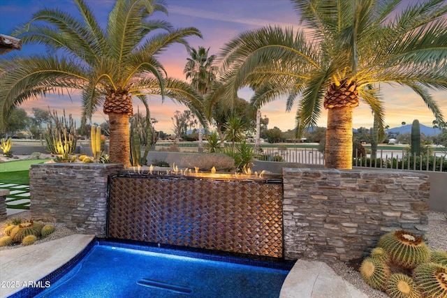 pool at dusk with a water view