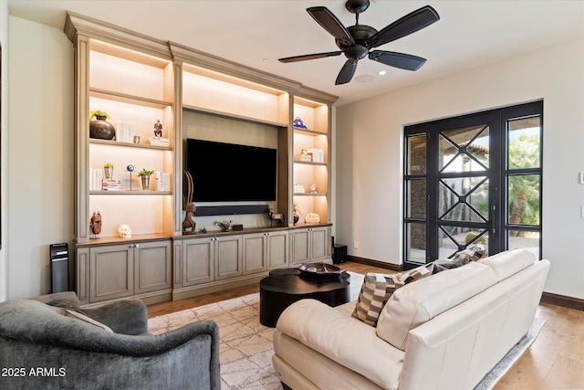 living room featuring ceiling fan and light hardwood / wood-style floors