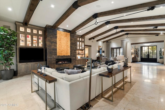 living room with a large fireplace and lofted ceiling with beams