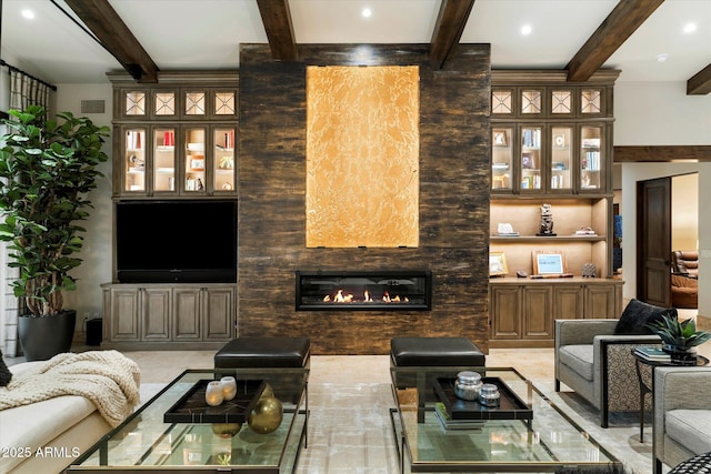 living room with beam ceiling and built in features