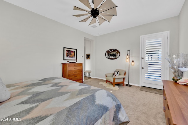 carpeted bedroom with access to outside and an inviting chandelier