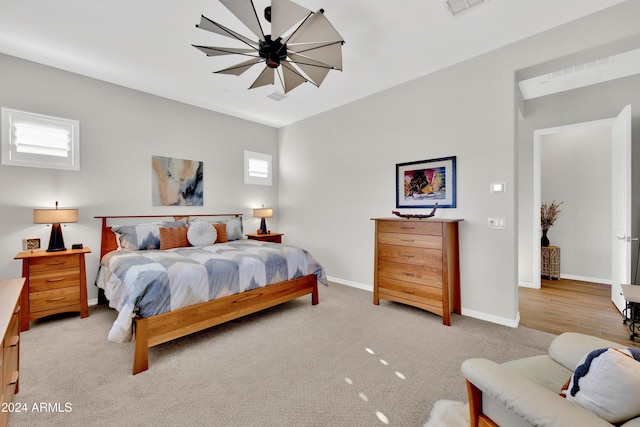 bedroom featuring light carpet and a notable chandelier