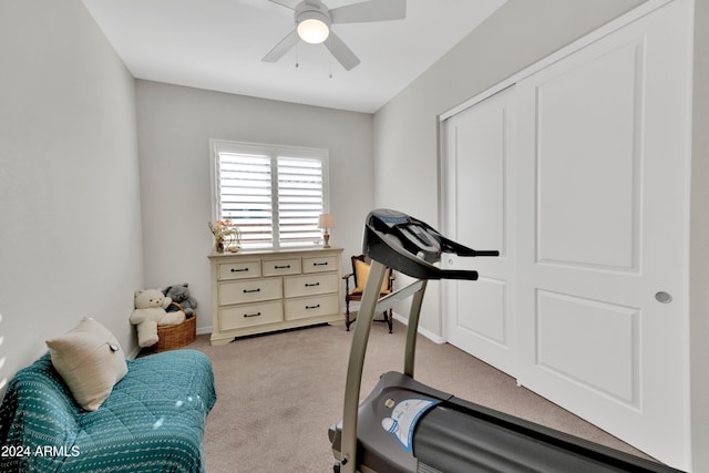 workout area with ceiling fan and light colored carpet