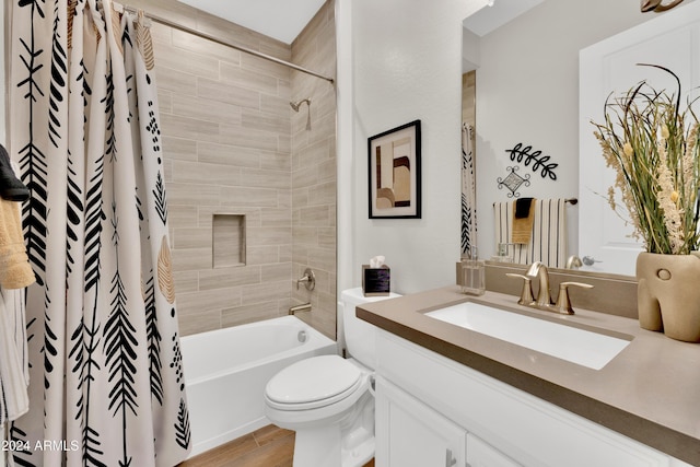 full bathroom featuring shower / bath combo, vanity, hardwood / wood-style flooring, and toilet