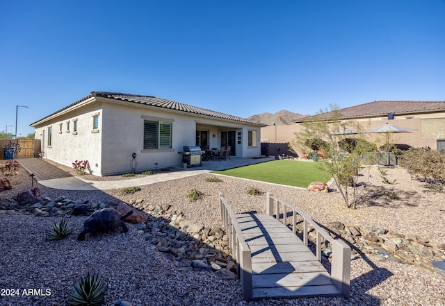 rear view of property featuring a yard and a patio area