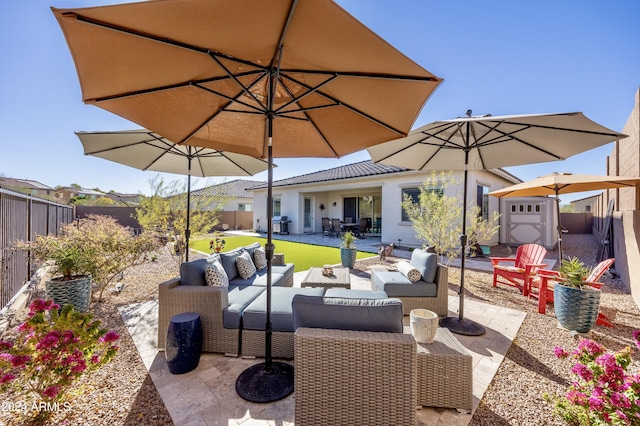 view of patio featuring an outdoor hangout area and a storage unit