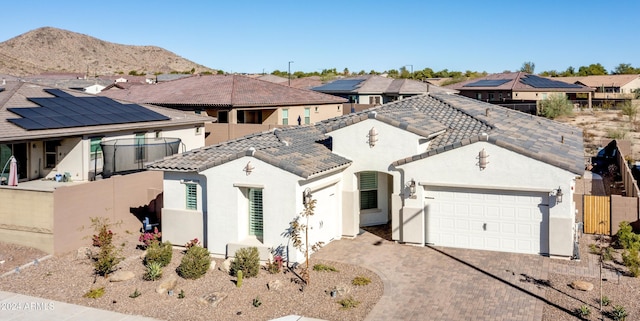 view of front of property featuring a mountain view and a garage