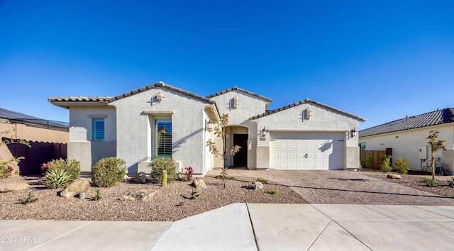 mediterranean / spanish-style house with a garage