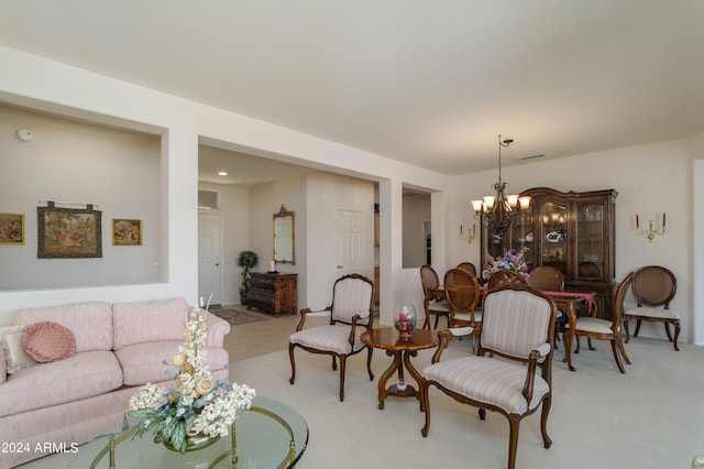 living room with light carpet and a notable chandelier