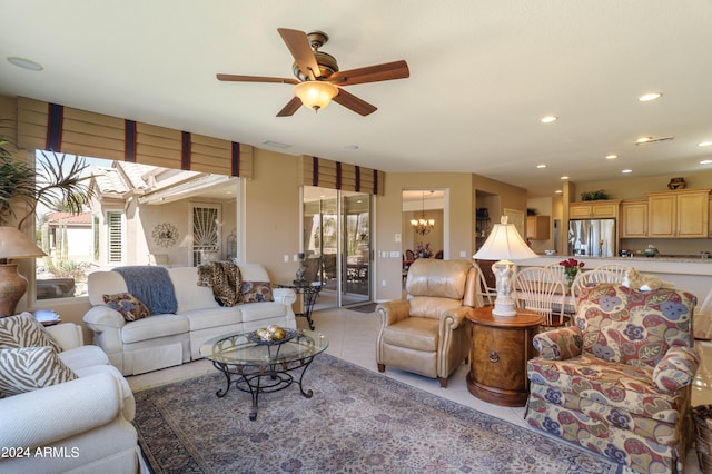 living room with ceiling fan with notable chandelier and light tile patterned floors