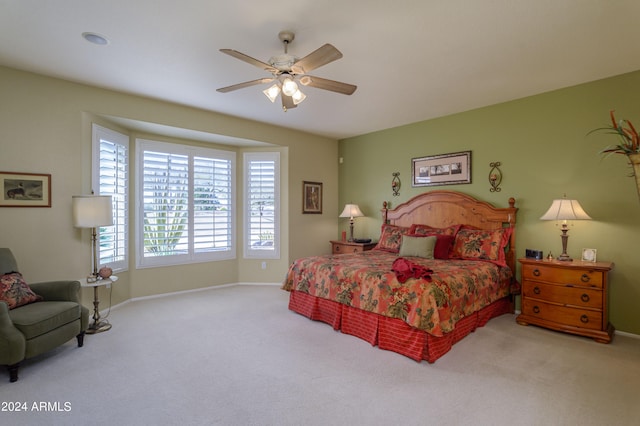 bedroom featuring ceiling fan and carpet