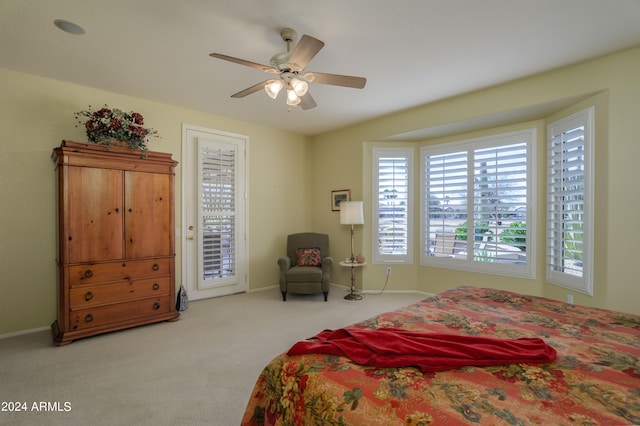 carpeted bedroom with ceiling fan and access to exterior