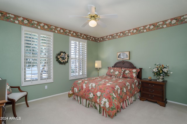 bedroom featuring ceiling fan and light carpet