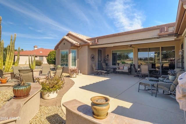 view of patio / terrace with an outdoor living space and ceiling fan