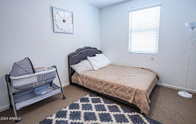 bedroom featuring dark carpet