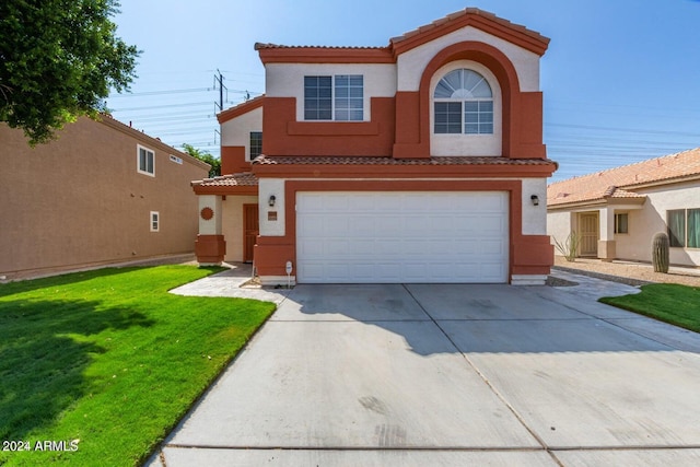 mediterranean / spanish home with a front yard and a garage