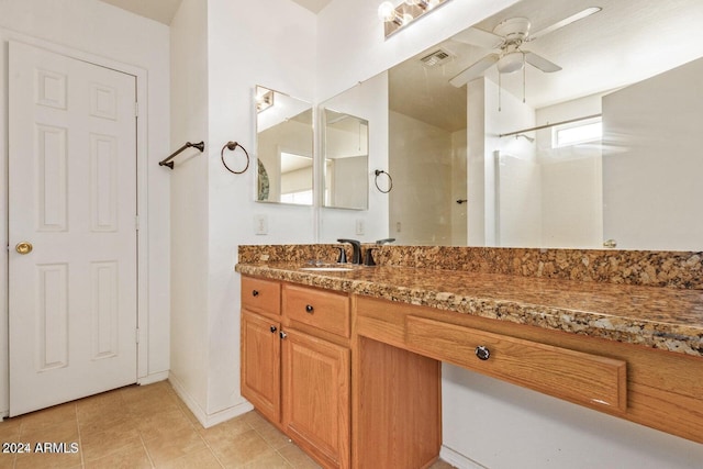 bathroom with tile patterned flooring, vanity, and ceiling fan