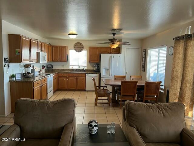 kitchen with ceiling fan, light tile patterned floors, sink, and white appliances