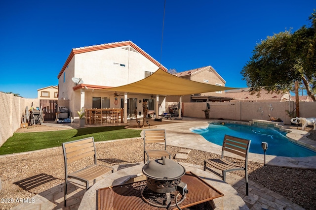 view of pool with ceiling fan and a patio area