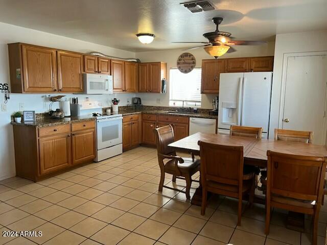 kitchen featuring light tile patterned floors, white appliances, ceiling fan, and sink