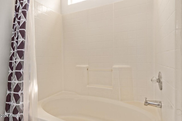 bathroom with shower / bath combination with curtain