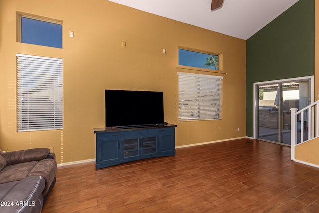 living room with dark hardwood / wood-style floors, high vaulted ceiling, and ceiling fan