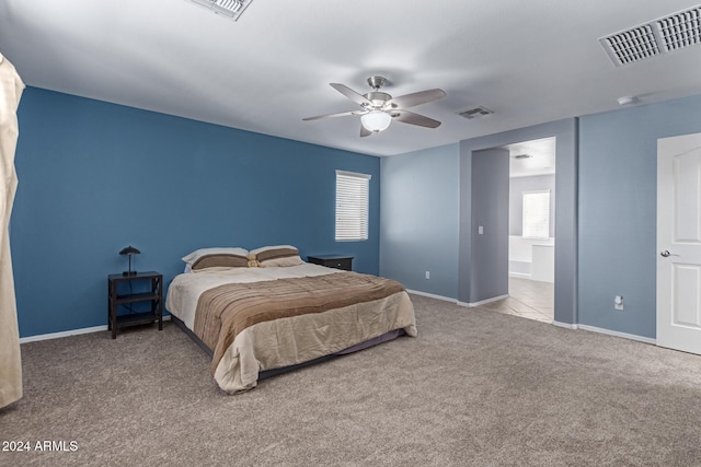 bedroom with ceiling fan and light colored carpet