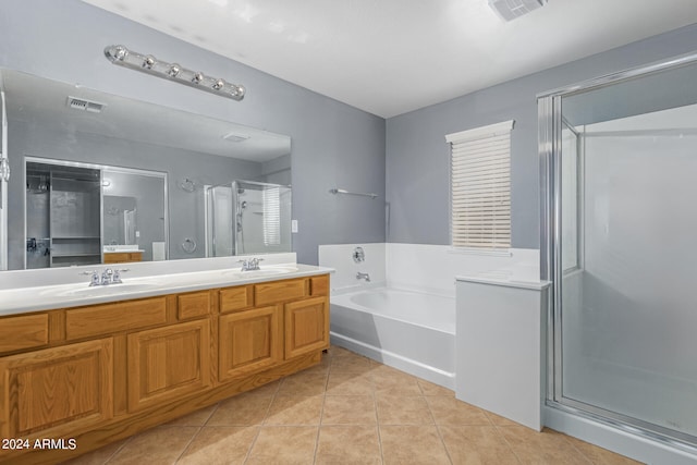 bathroom featuring vanity, plus walk in shower, and tile patterned flooring