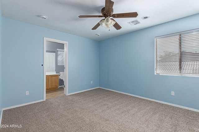 carpeted spare room featuring ceiling fan