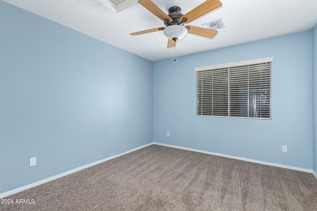 carpeted spare room featuring ceiling fan