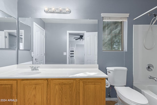 full bathroom featuring vanity, toilet,  shower combination, and ceiling fan