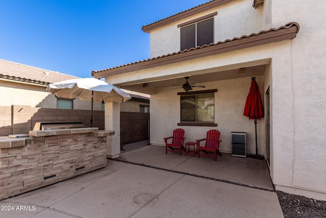 view of patio with area for grilling and ceiling fan