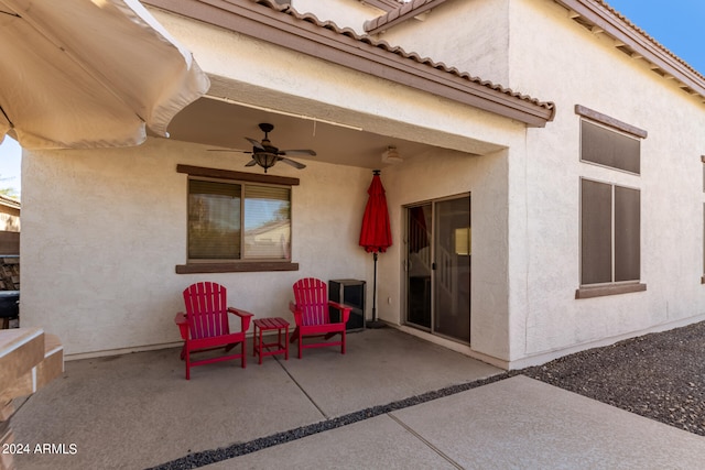 rear view of property with a patio area and ceiling fan