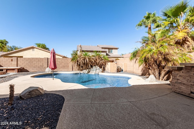 view of swimming pool with a patio area and pool water feature