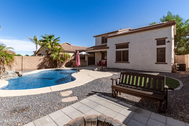 view of pool with central air condition unit and a patio area