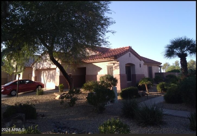 mediterranean / spanish-style house featuring a garage