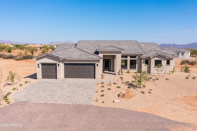 view of front of home with a mountain view and a garage