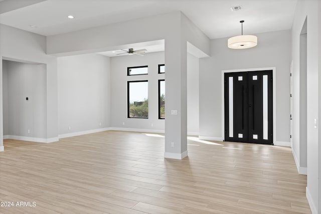 foyer with light hardwood / wood-style floors and ceiling fan