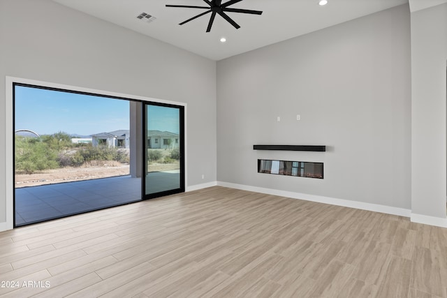 unfurnished living room featuring light hardwood / wood-style floors and ceiling fan