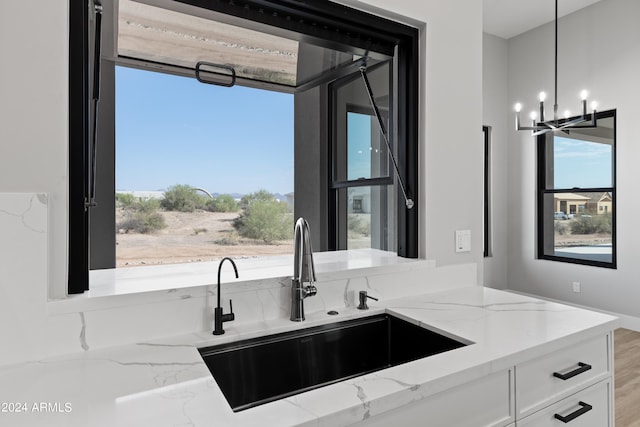 bathroom with vanity, a notable chandelier, and wood-type flooring