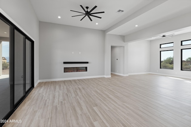 unfurnished living room featuring light hardwood / wood-style floors and ceiling fan