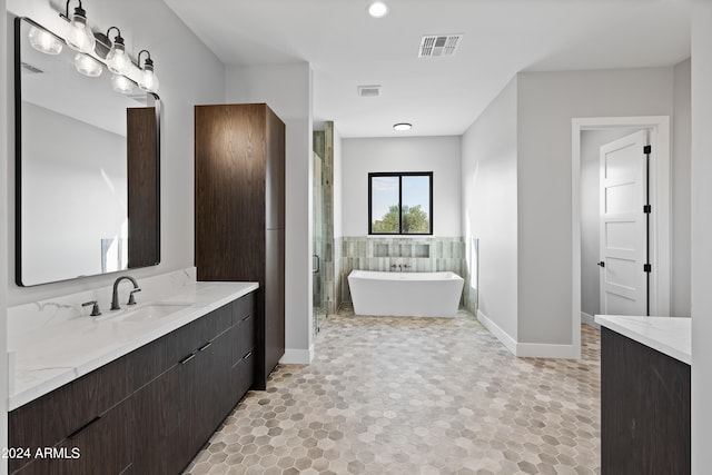 bathroom with vanity and independent shower and bath