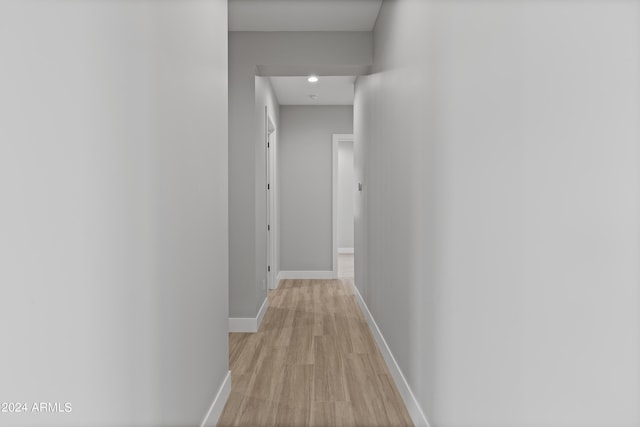 hallway with light hardwood / wood-style flooring