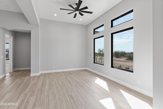 spare room with light hardwood / wood-style floors and ceiling fan